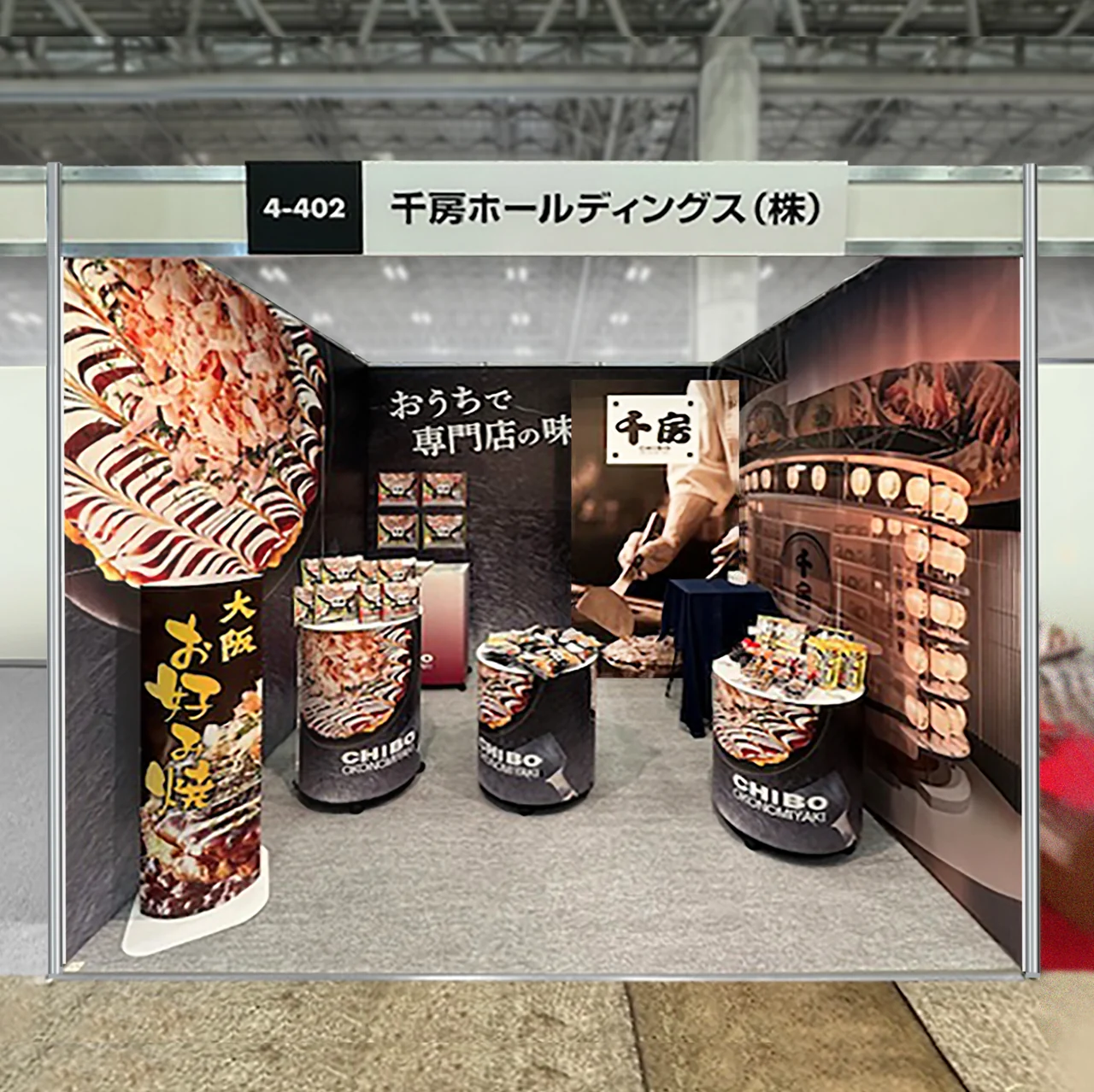 お好み焼きの写真を壁面と展示台に印刷した千房ホールディングス様の展示会ブース